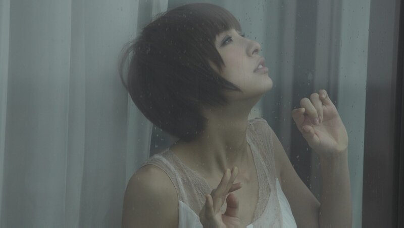 woman at rainy window