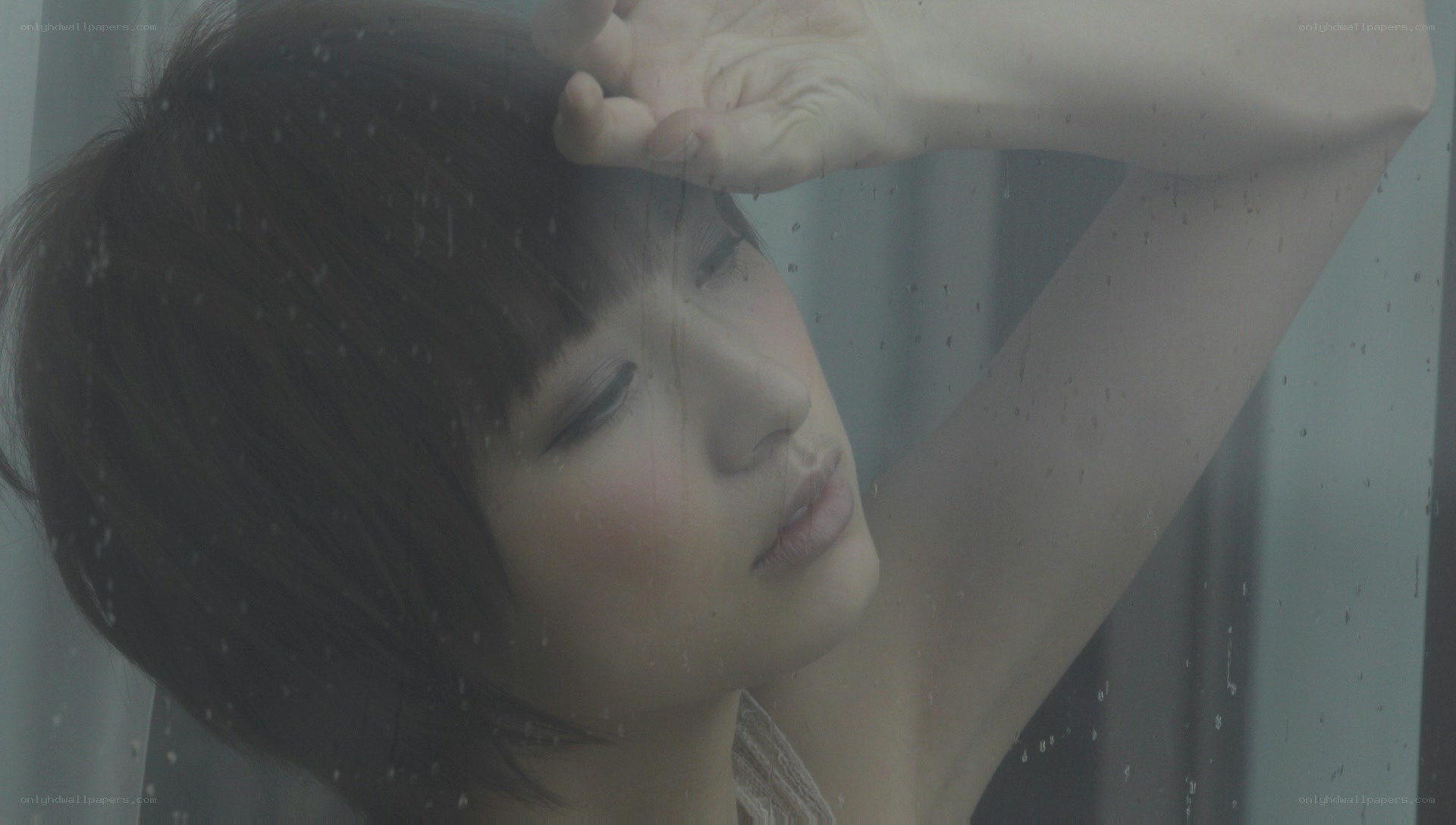 woman at rainy window