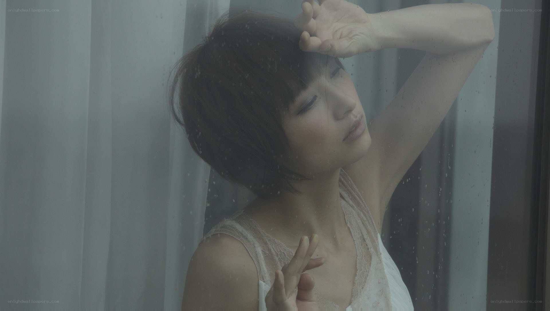 woman at rainy window