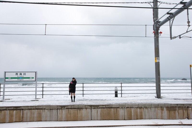 Woman at snowy train station