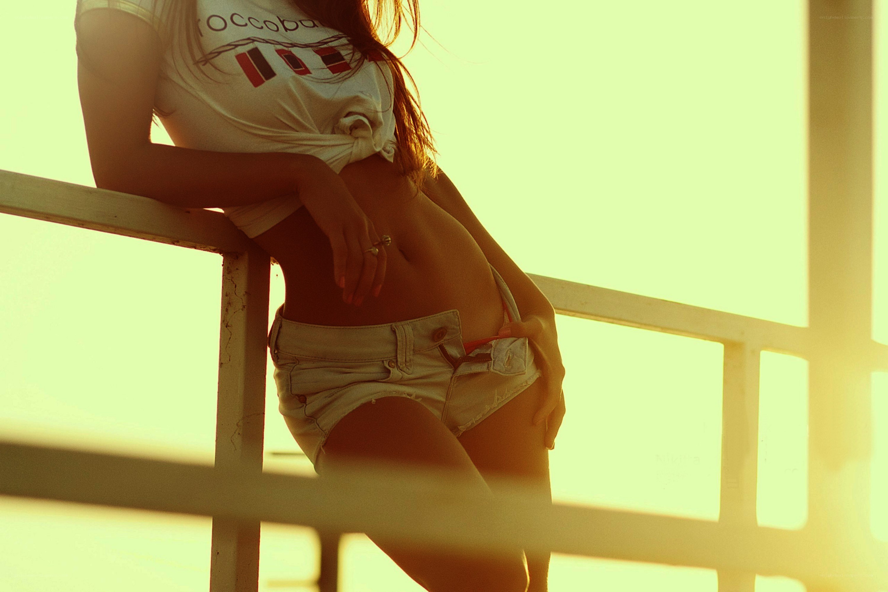 woman at sunset by railing