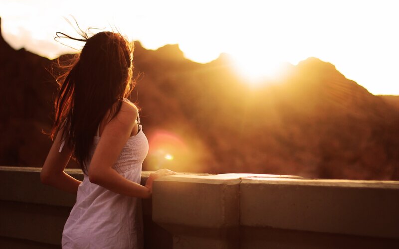 woman at sunset by the mountains
