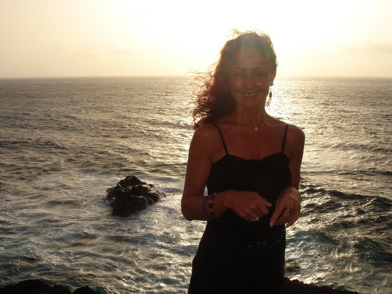 Woman at sunset by the ocean