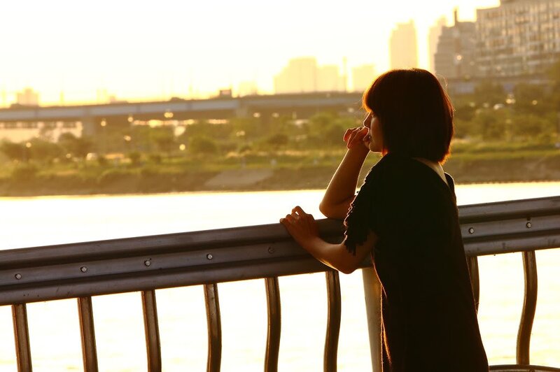 woman at sunset by the river