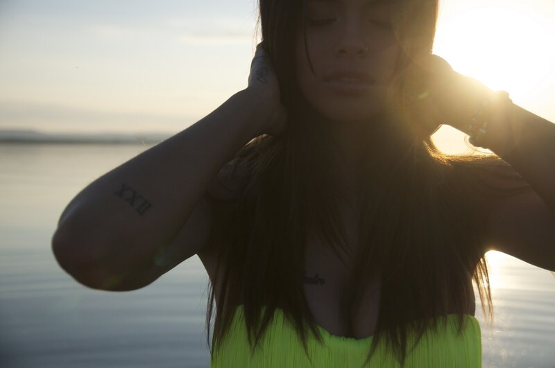 woman at sunset by water