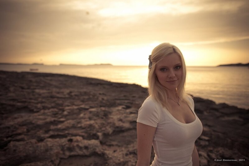 Woman at sunset on rocky shore