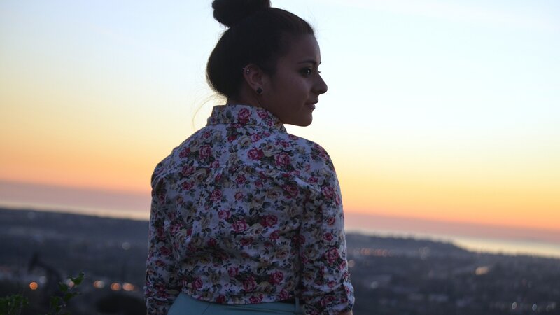 woman at sunset overlooking city