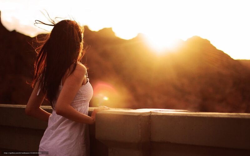 woman at sunset overlooking mountains