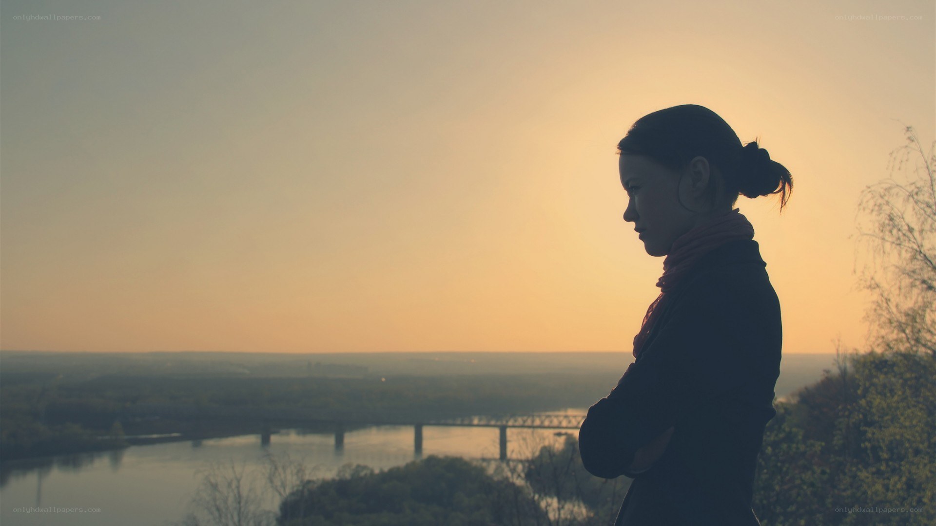 woman at sunset overlooking river