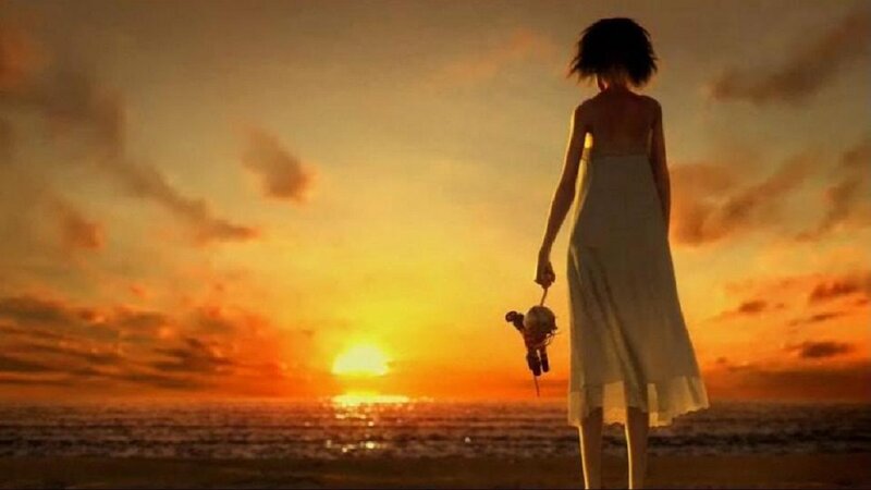 woman at sunset with doll