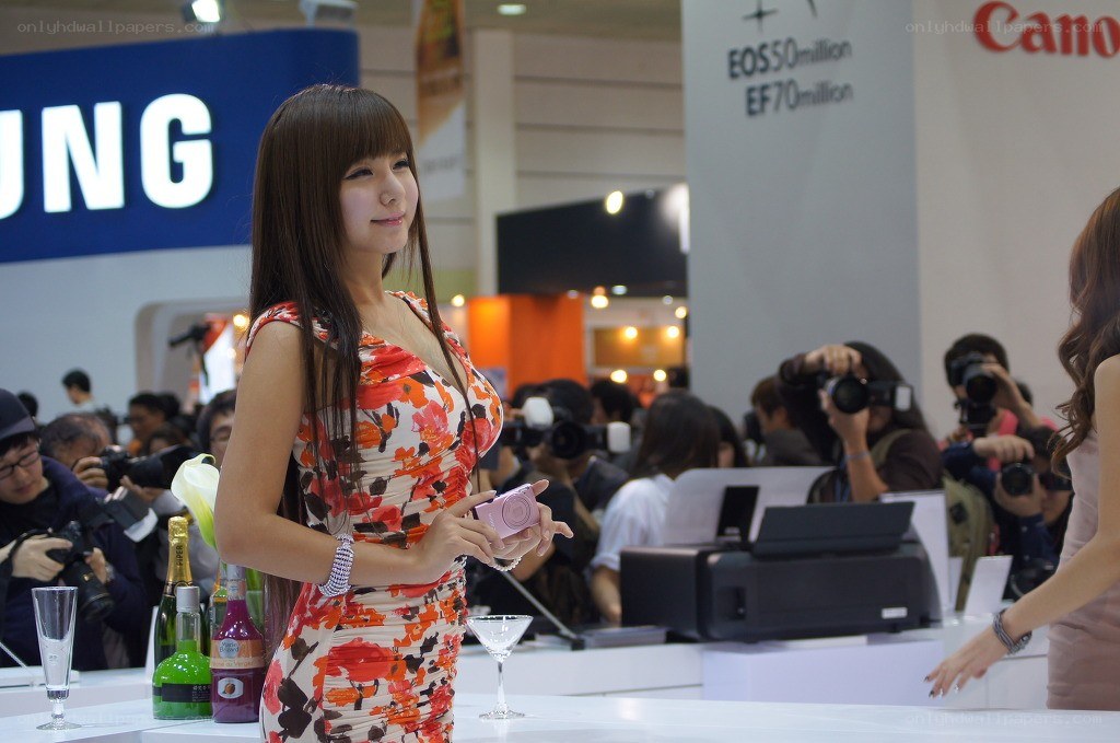 Woman at tech expo with camera
