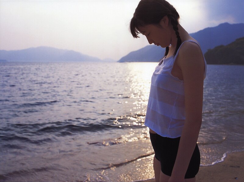 Woman at the beach at sunset