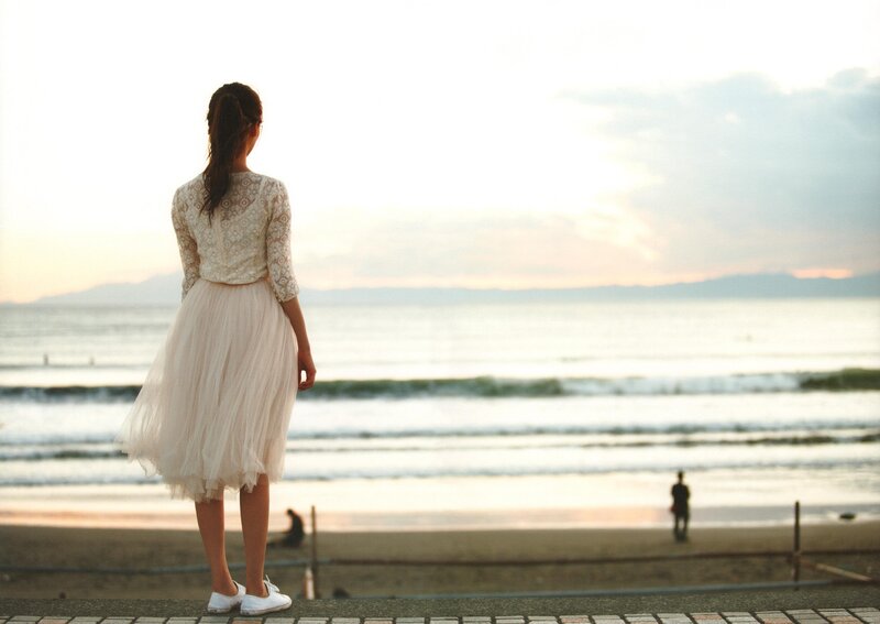 Woman at the beach at sunset