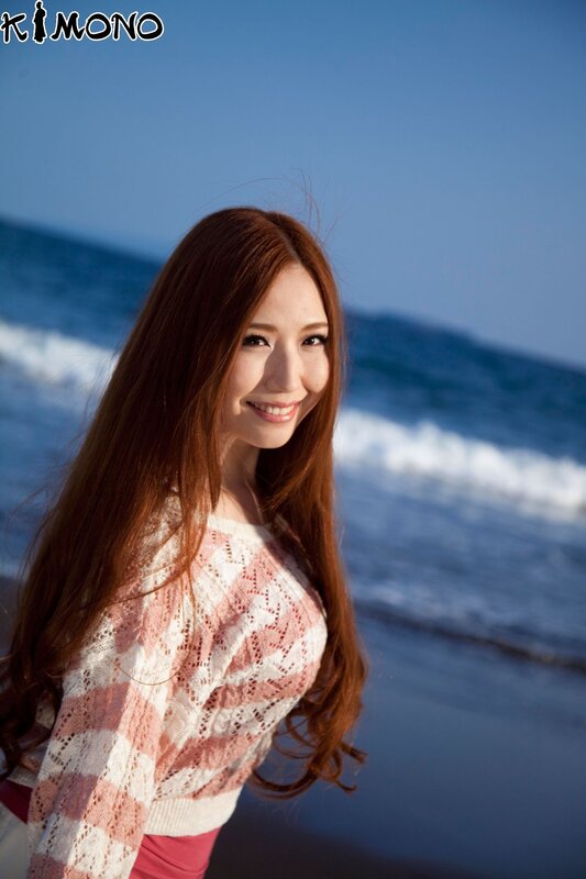 Woman at the beach in a sweater