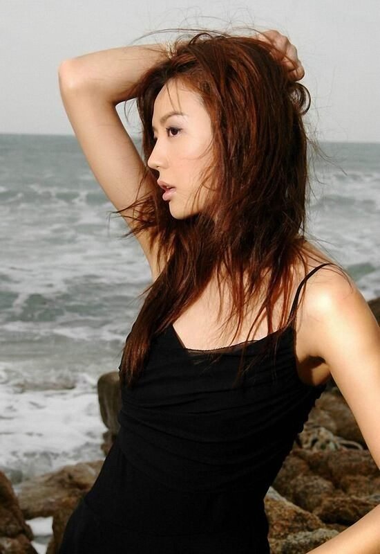woman at the beach in black dress