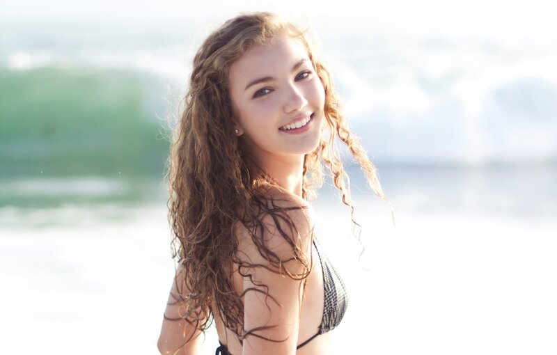 woman at the beach smiling