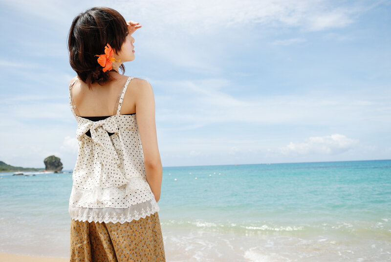 Woman at the beach with flower
