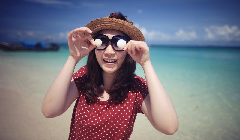 Woman at the beach with seashells