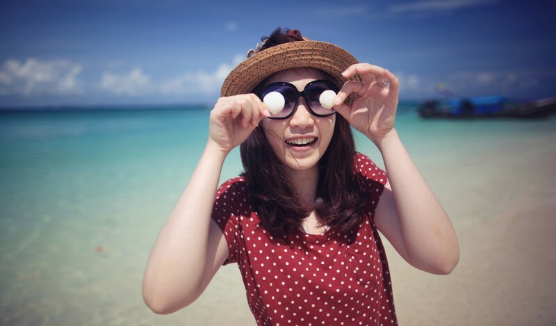 woman at tropical beach with sunglasses