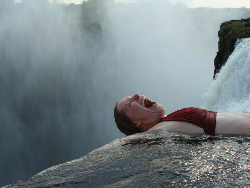 Woman at waterfall edge