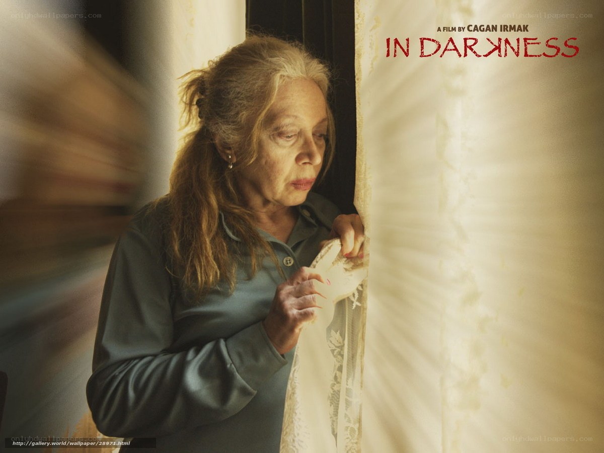 woman at window in darkness