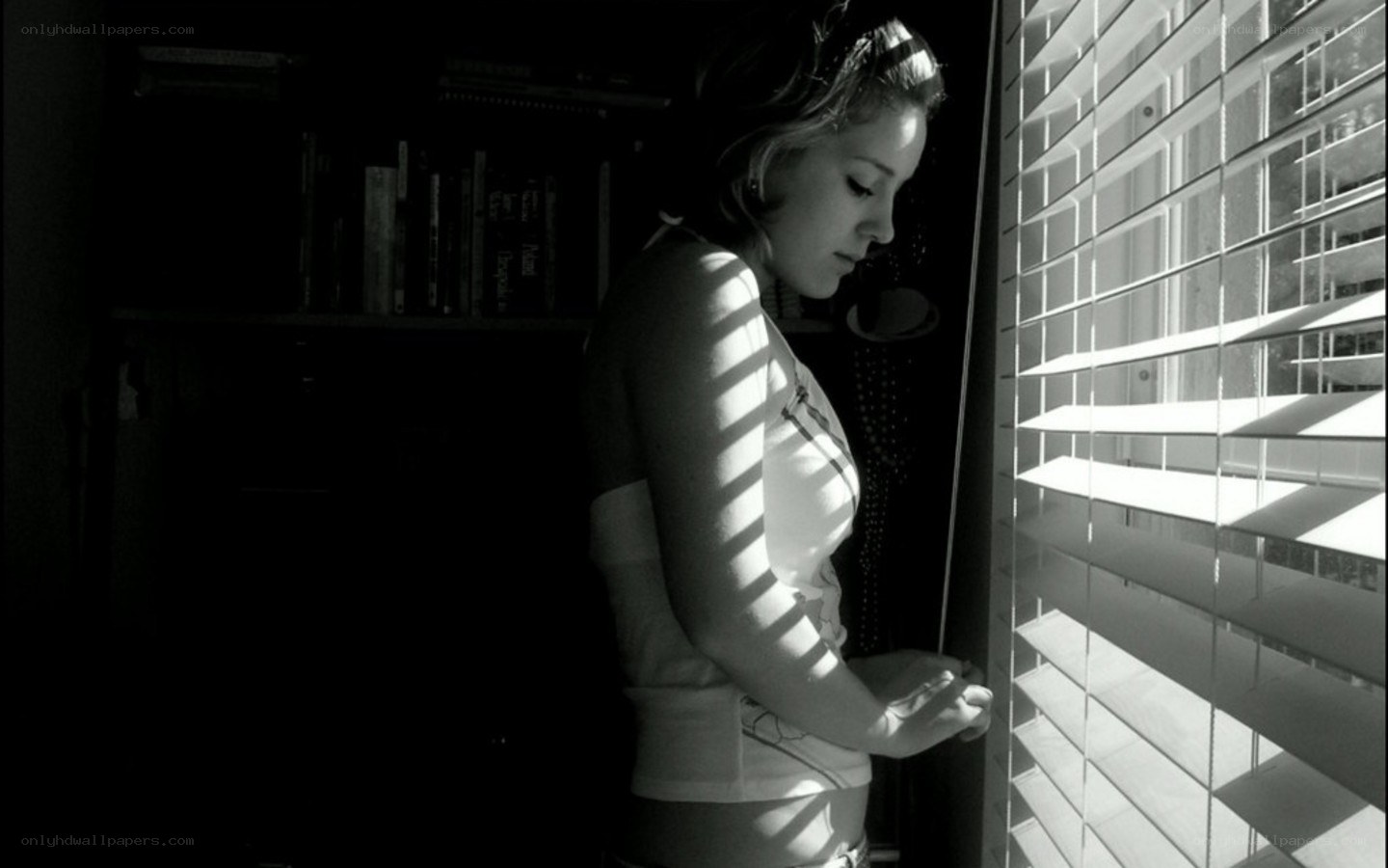 woman at window with blinds