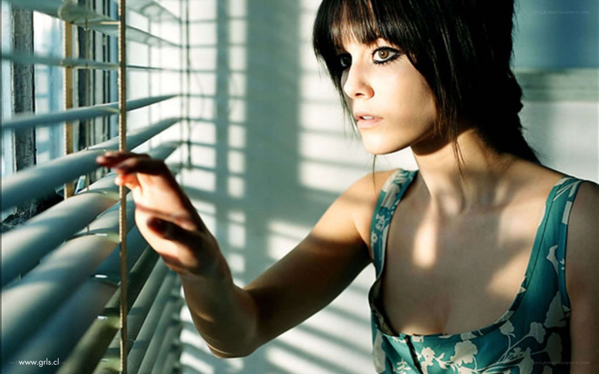woman at window with blinds