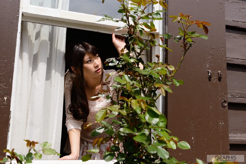 woman at window with plant