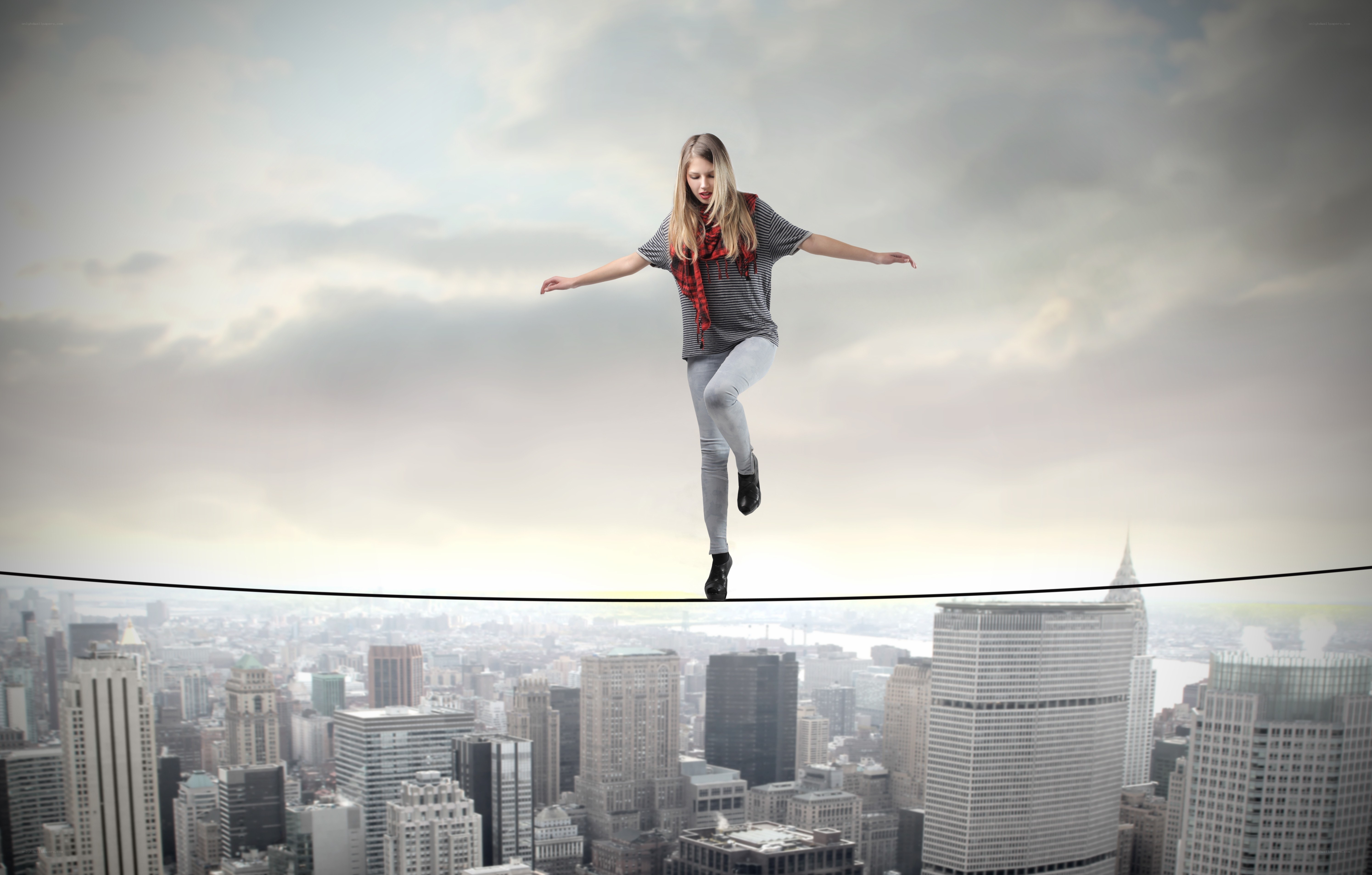 Woman balancing on tightrope