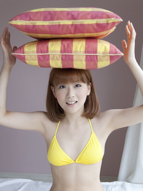 Woman balancing pillows on head