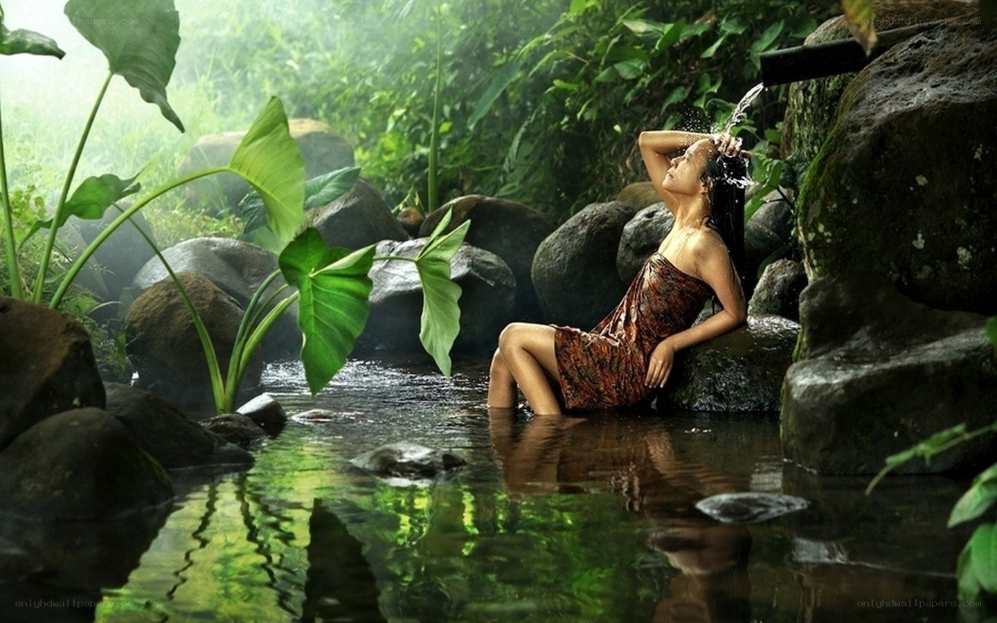 Woman bathing in jungle stream