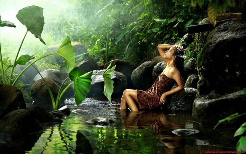 Woman bathing in jungle stream