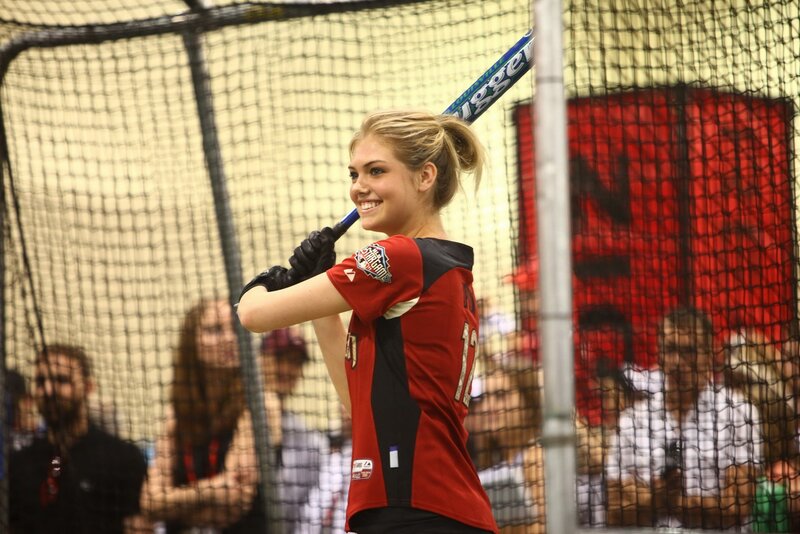 woman batting in a cage