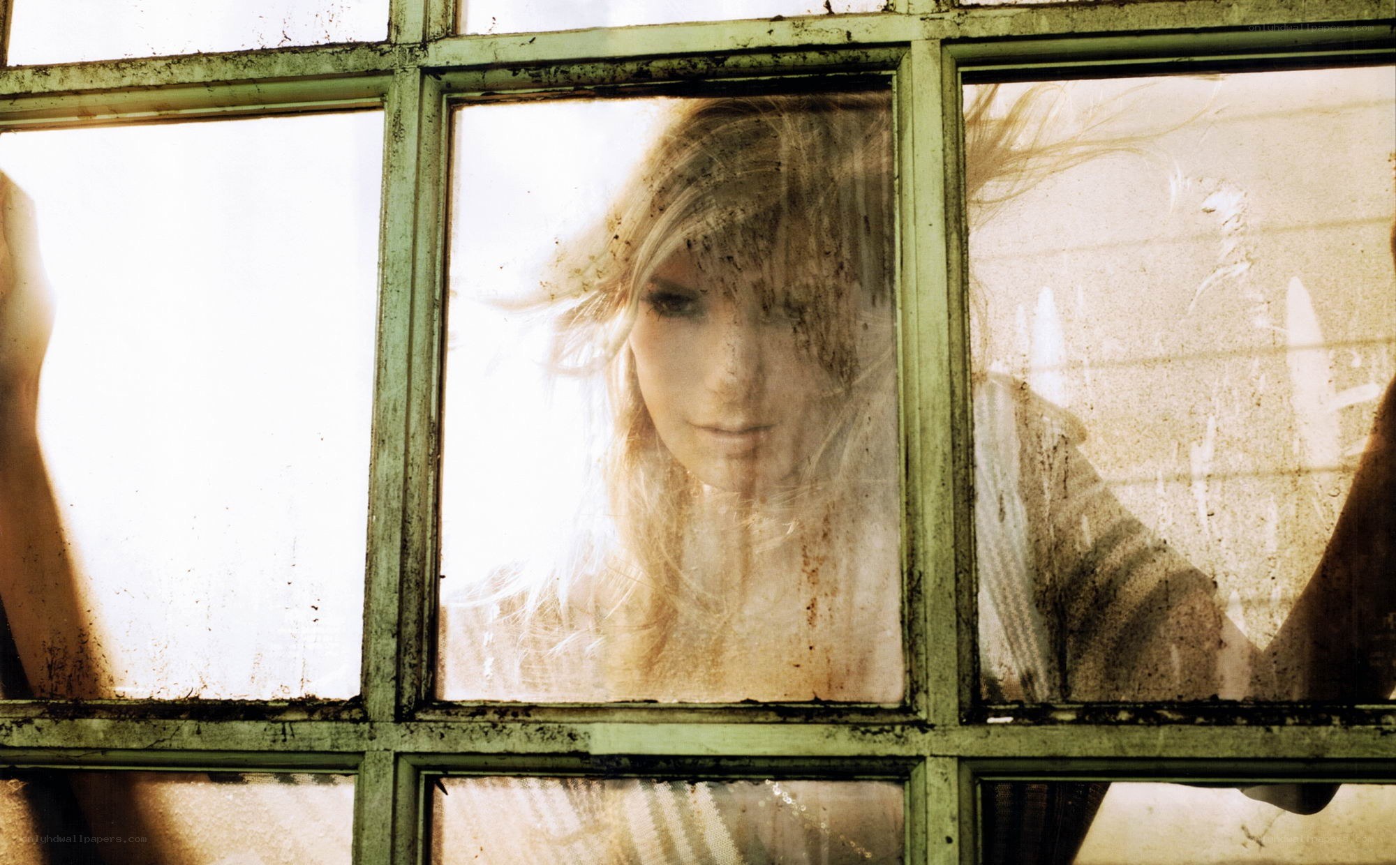 woman behind a dirty window