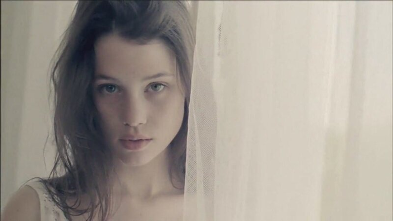 woman behind a sheer curtain