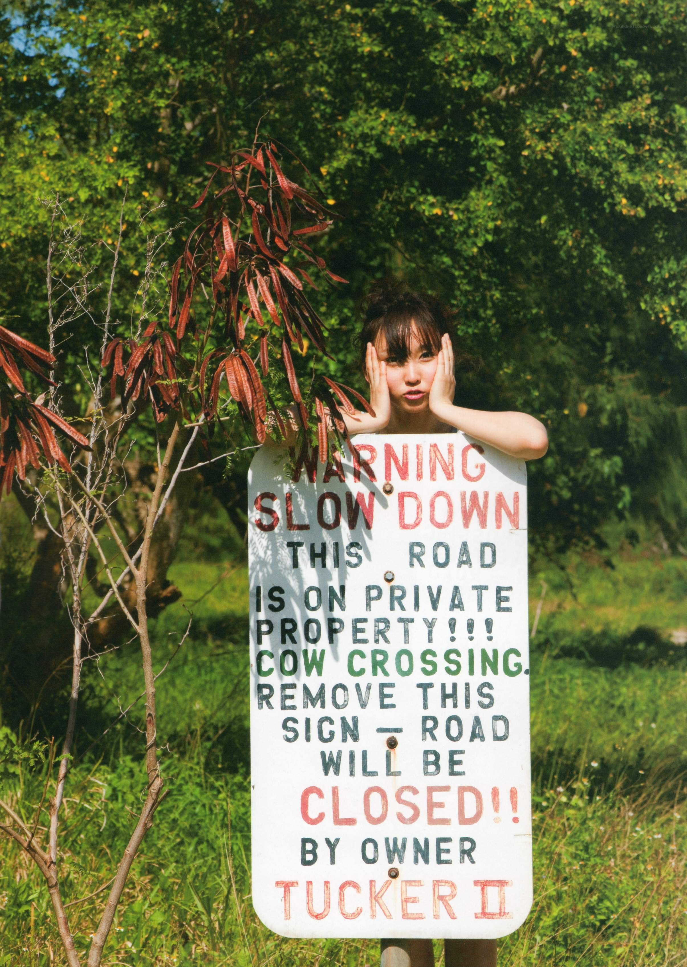 Woman behind a warning sign
