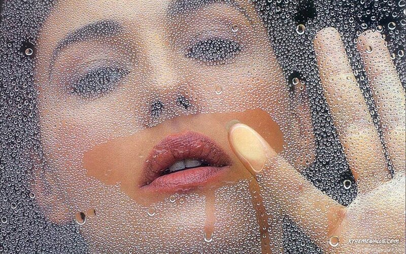 woman behind a wet glass