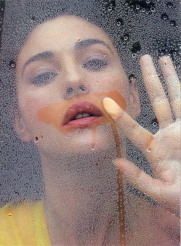 woman behind a wet glass