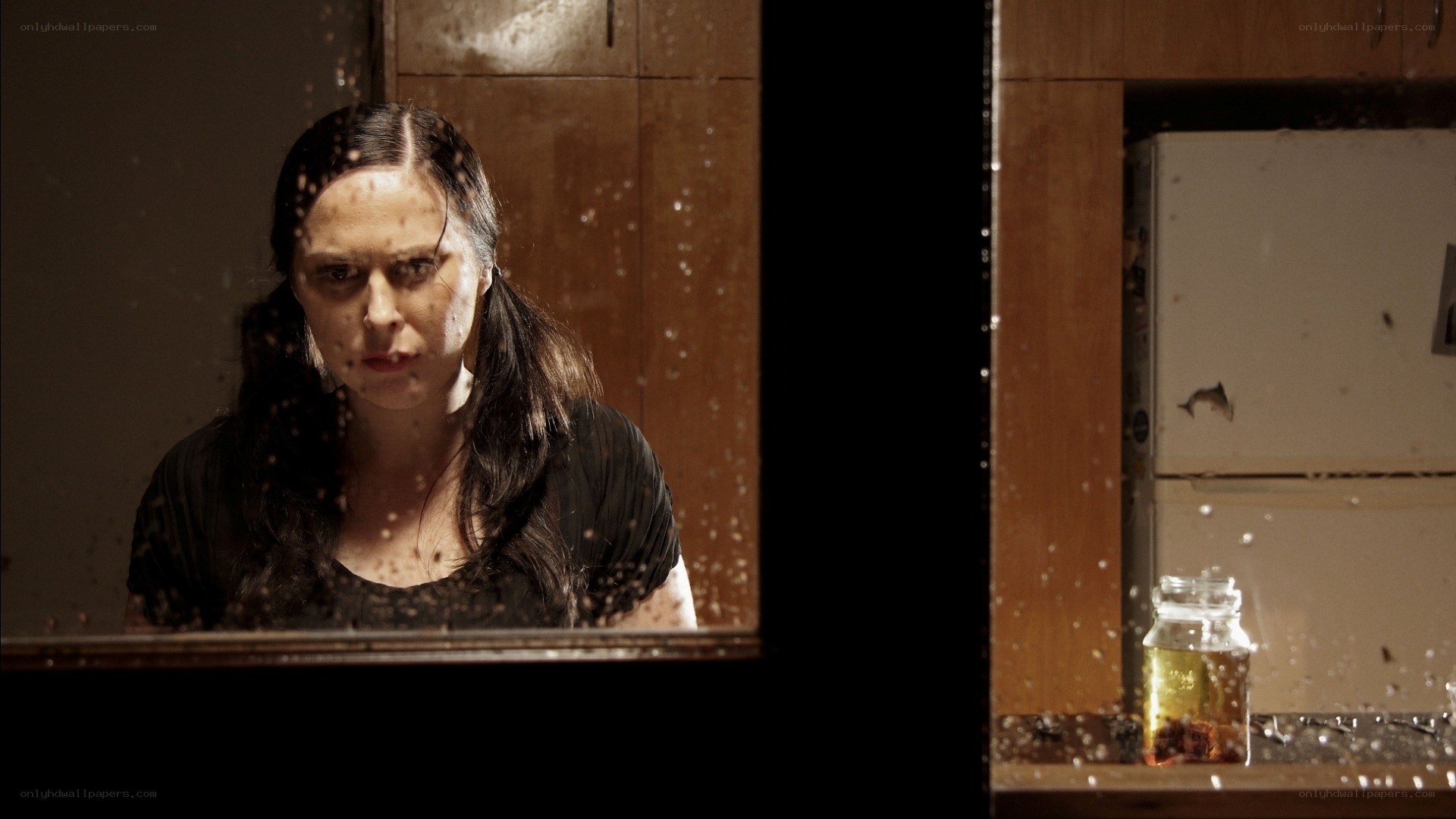 woman behind a wet window