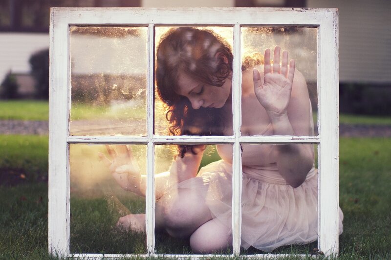 woman behind a window frame