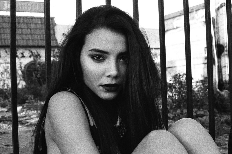woman behind bars in black and white