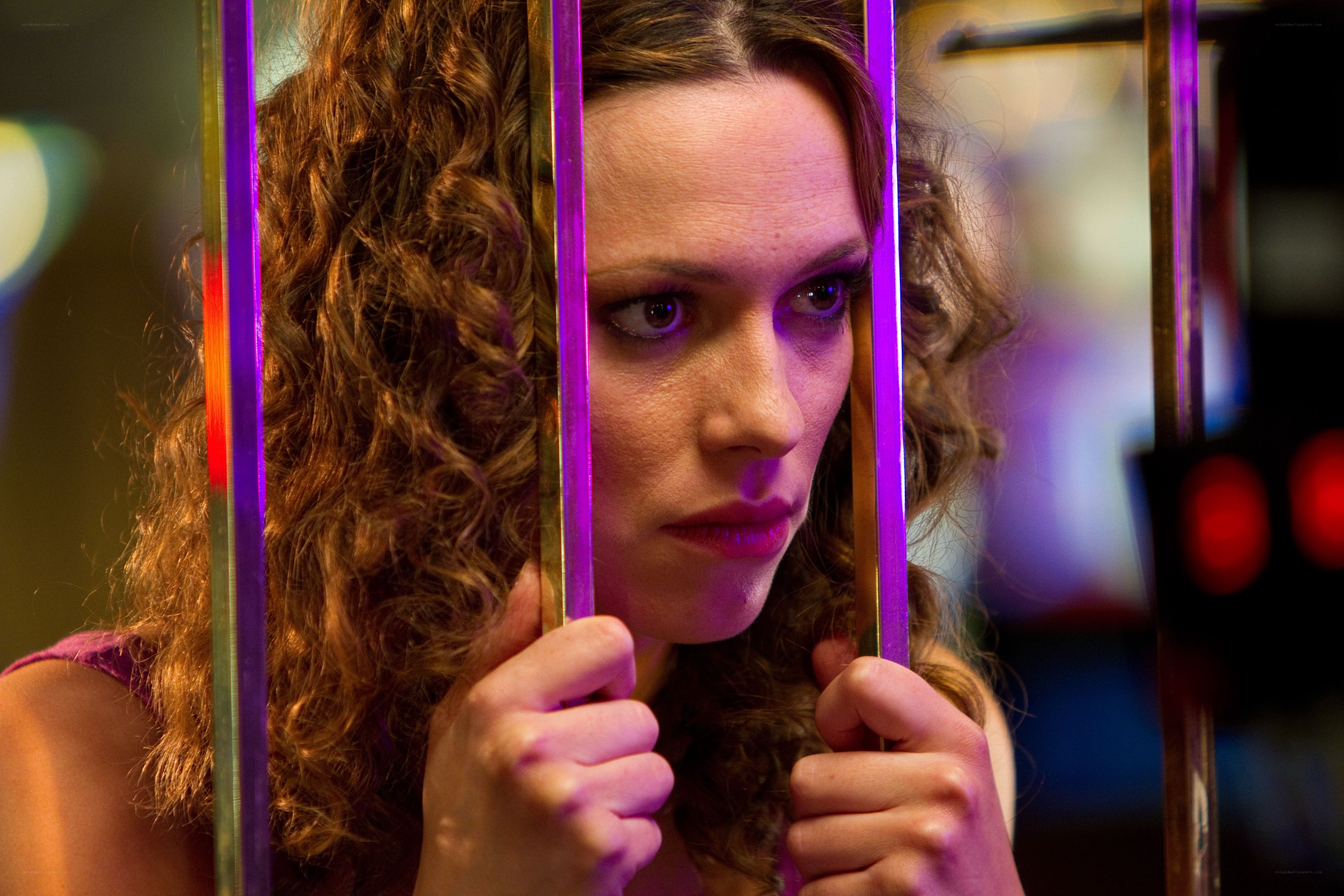 woman behind bars in purple light