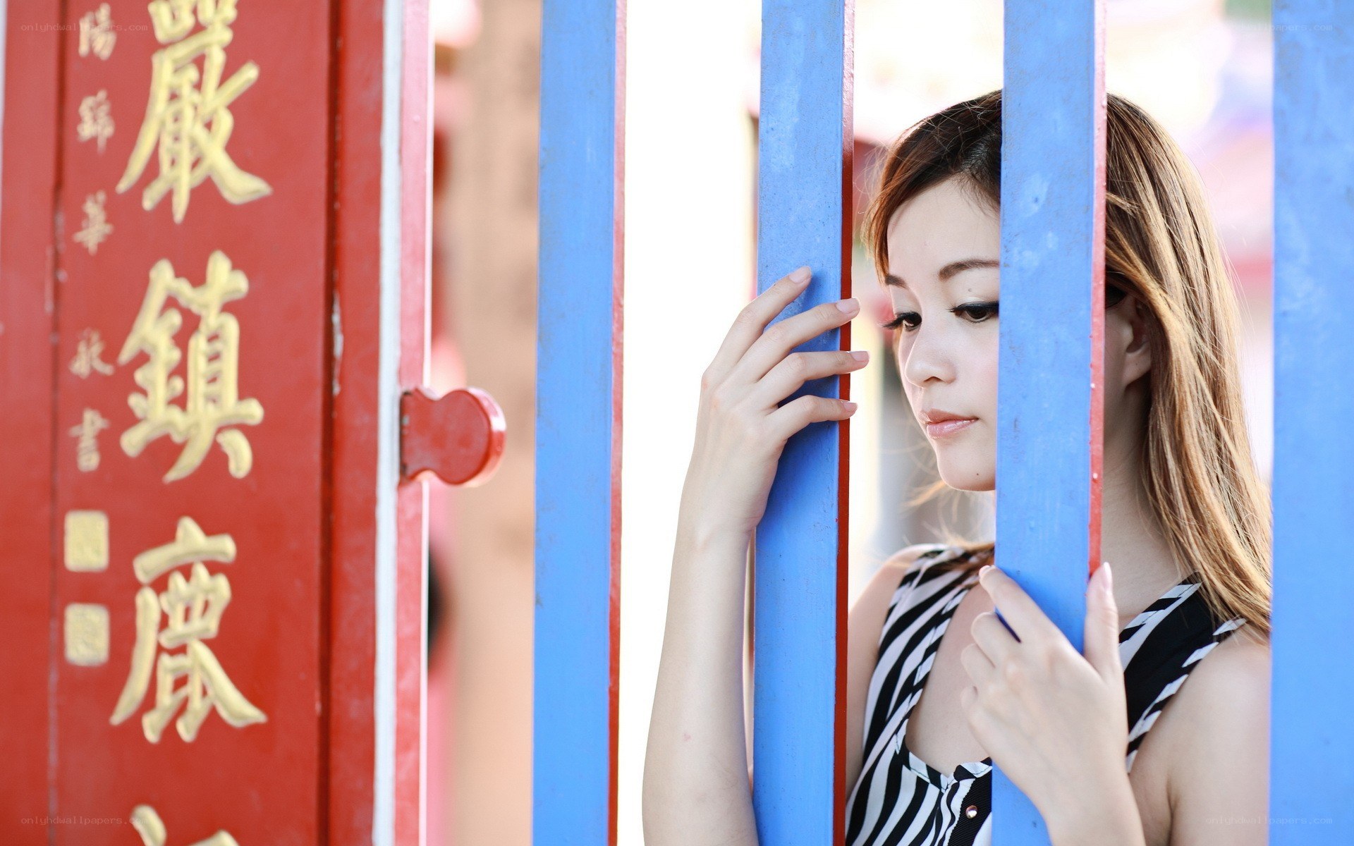 woman behind blue bars