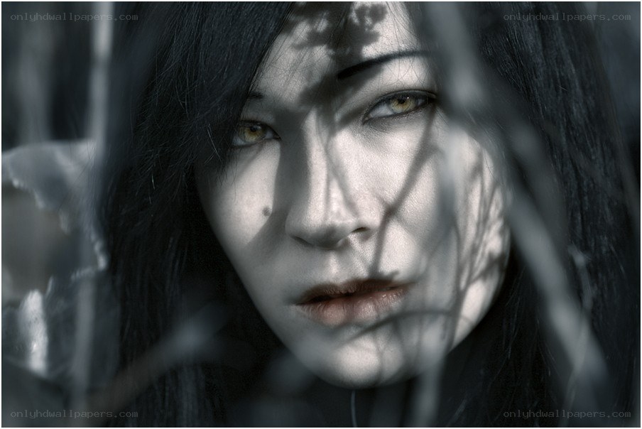 woman behind branches