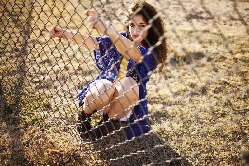 woman behind chain-link fence
