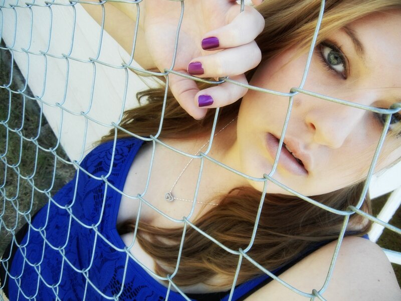 woman behind chain-link fence