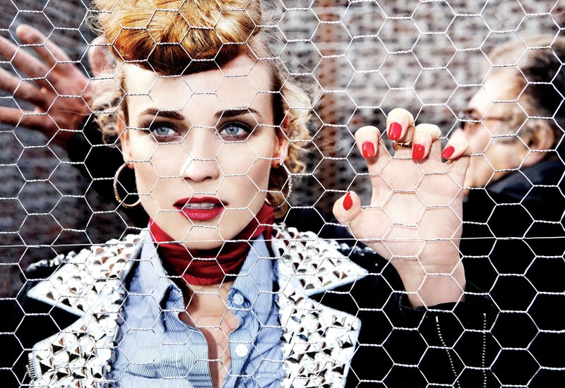 woman behind chicken wire fence