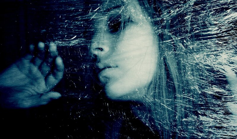 woman behind cracked glass