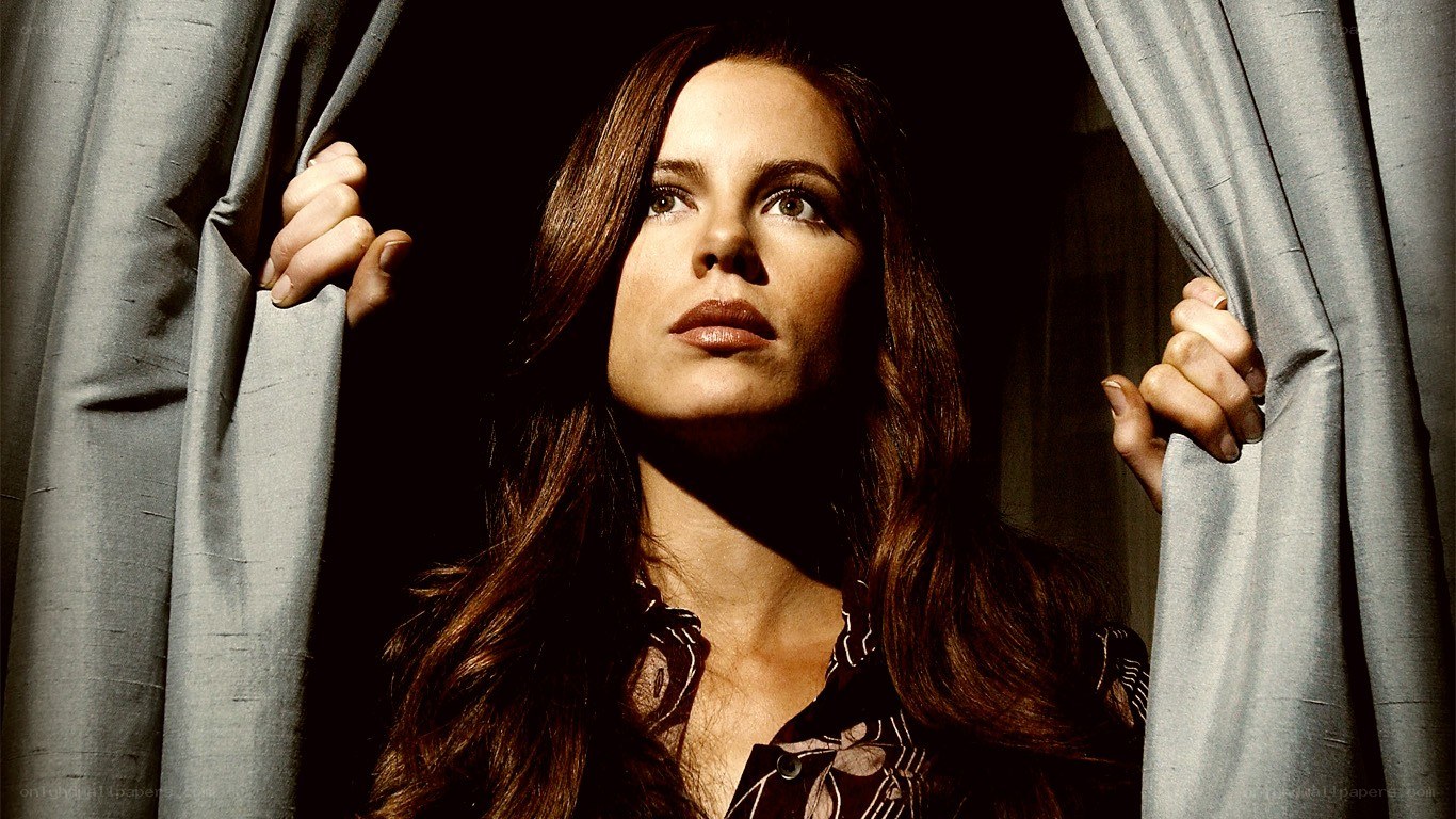 woman behind curtains