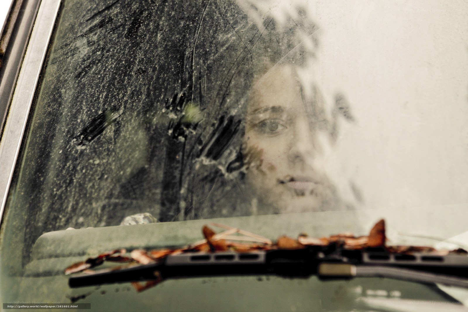 woman behind dirty windshield